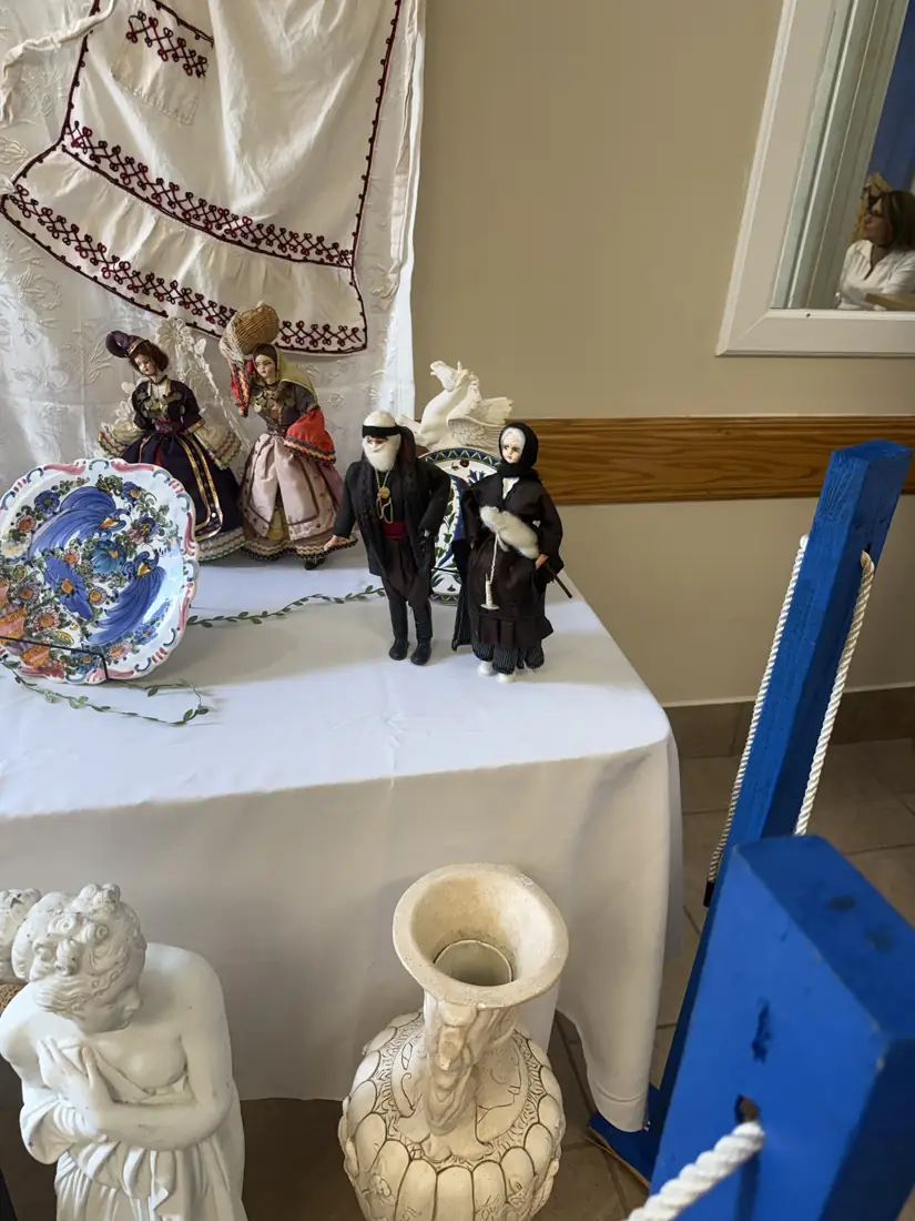 A display of traditional Greek dolls, embroidery and painted ceramics at Greek Fest